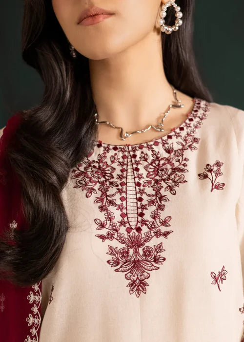 Close-up of intricate ivory threadwork on the neckline of the Rua shirt.