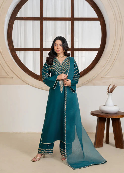 Model wearing Jazmine Teal 3-piece embroidered luxury suit with dupatta by Afsura.