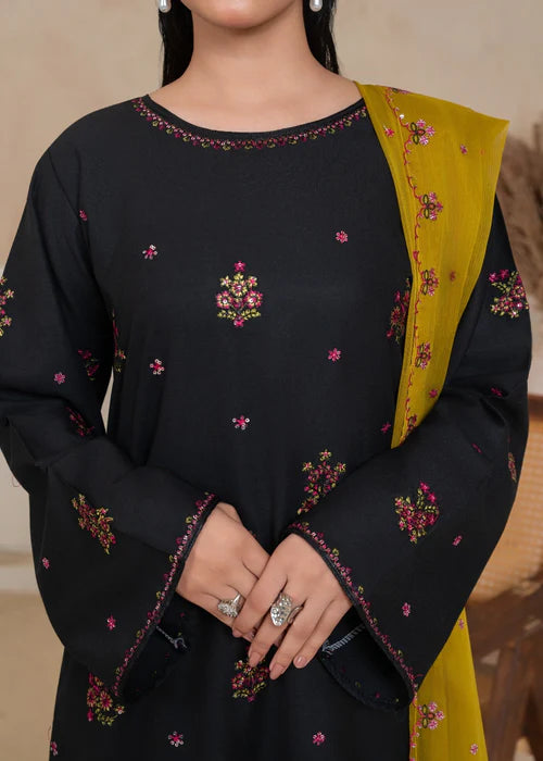 lose-up of intricate black-on-black floral threadwork on the neckline.