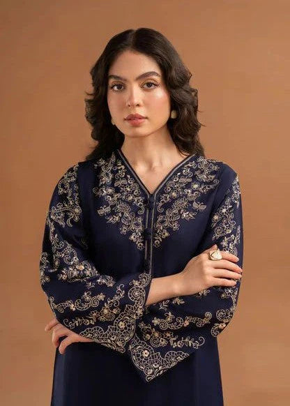 Close-up of gold and ivory intricate embroidery on a navy blue V-neckline.