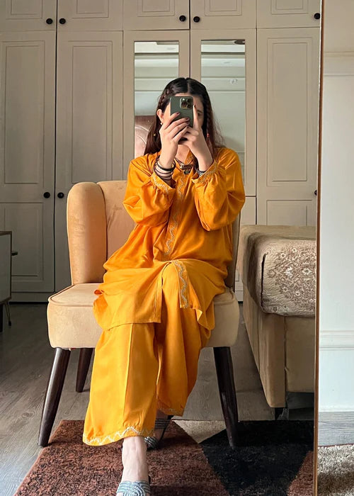 Model wearing Yellow Ringels 2-piece embroidered suit with ivory scalloped details by Afsura.